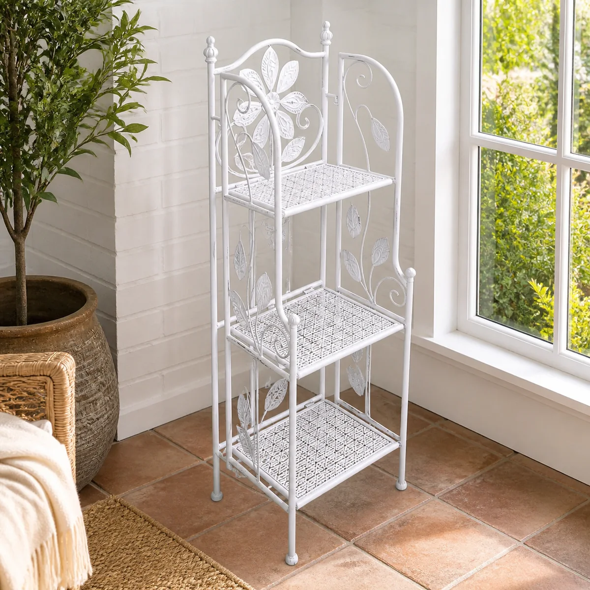 Etosha Corner Plant Stand staged in a light-filled sunroom.